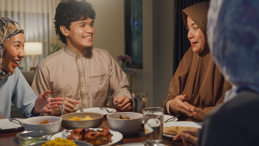Family sharing food at dining table during Ramadan iftar meal