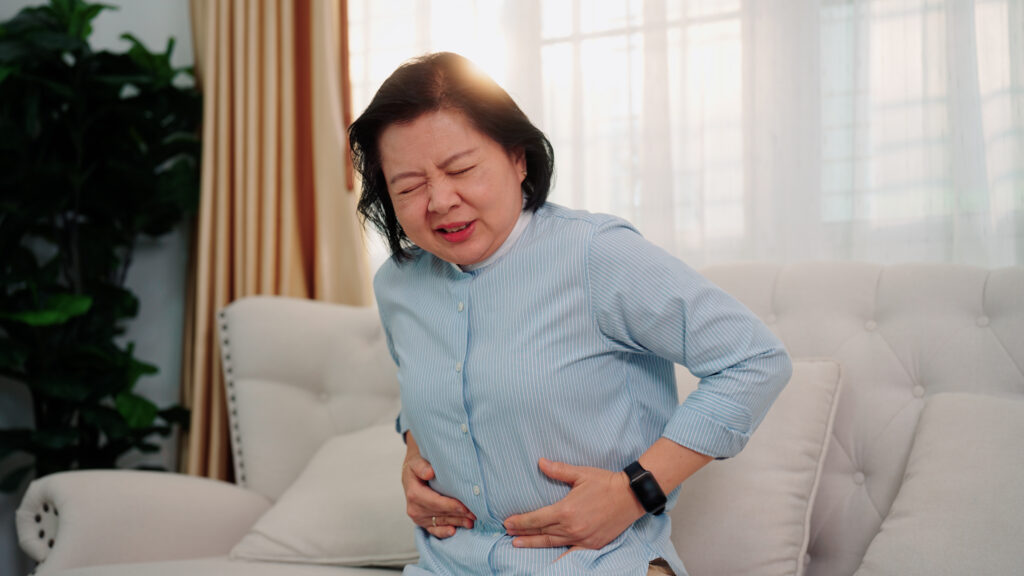 Woman experiencing stomach pain after CNY celebrations