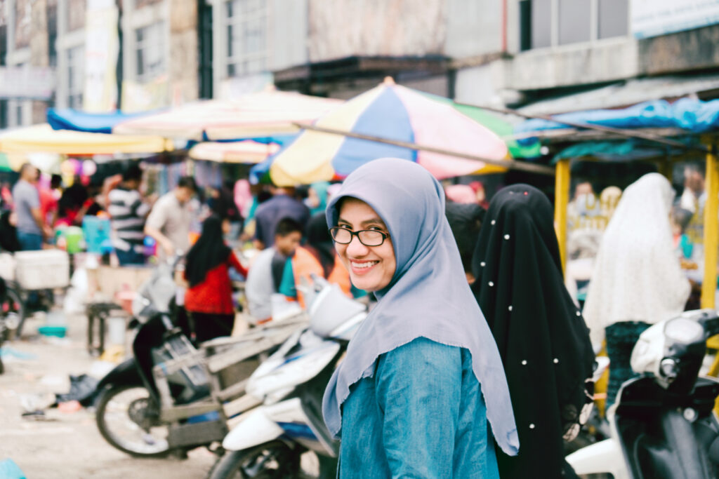 Smiling girl at market choosing food carefully to avoid digestive issues