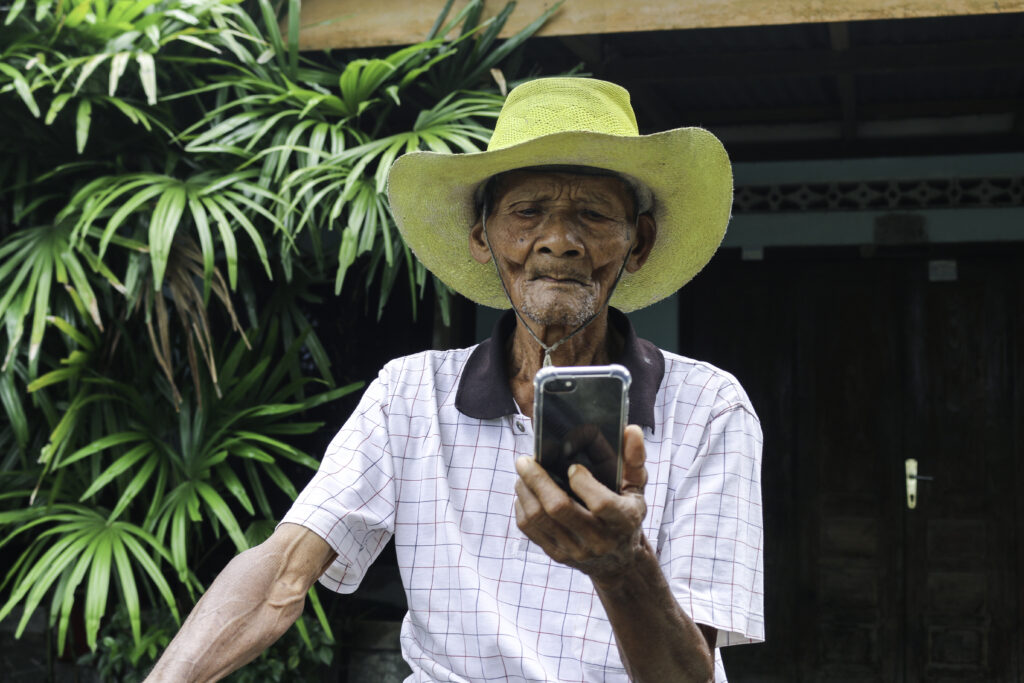 Elderly man using smartphone for senior healthcare information and support
