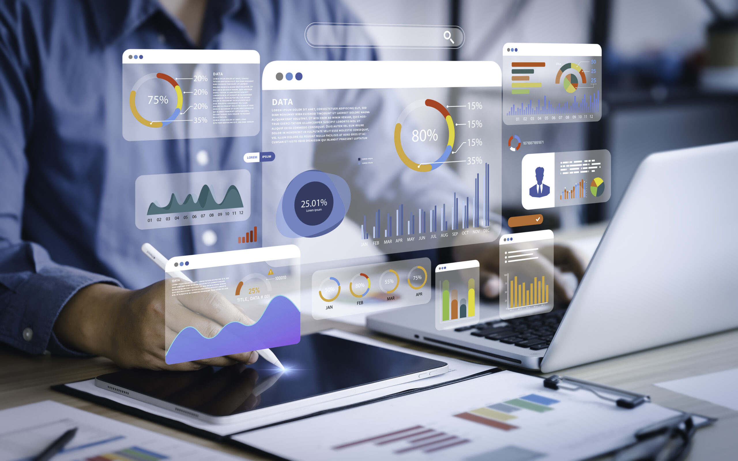 Person using tablet and laptop reviewing FEV3R healthcare data and analytics dashboard