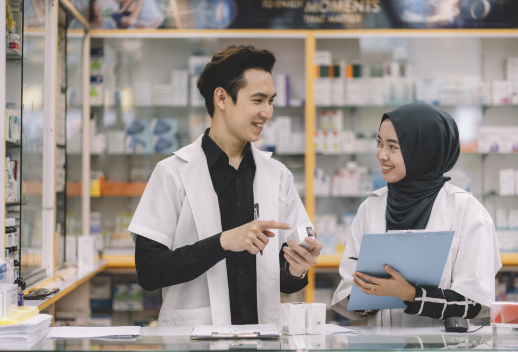 Pharmacists discussing medication inside a pharmacy