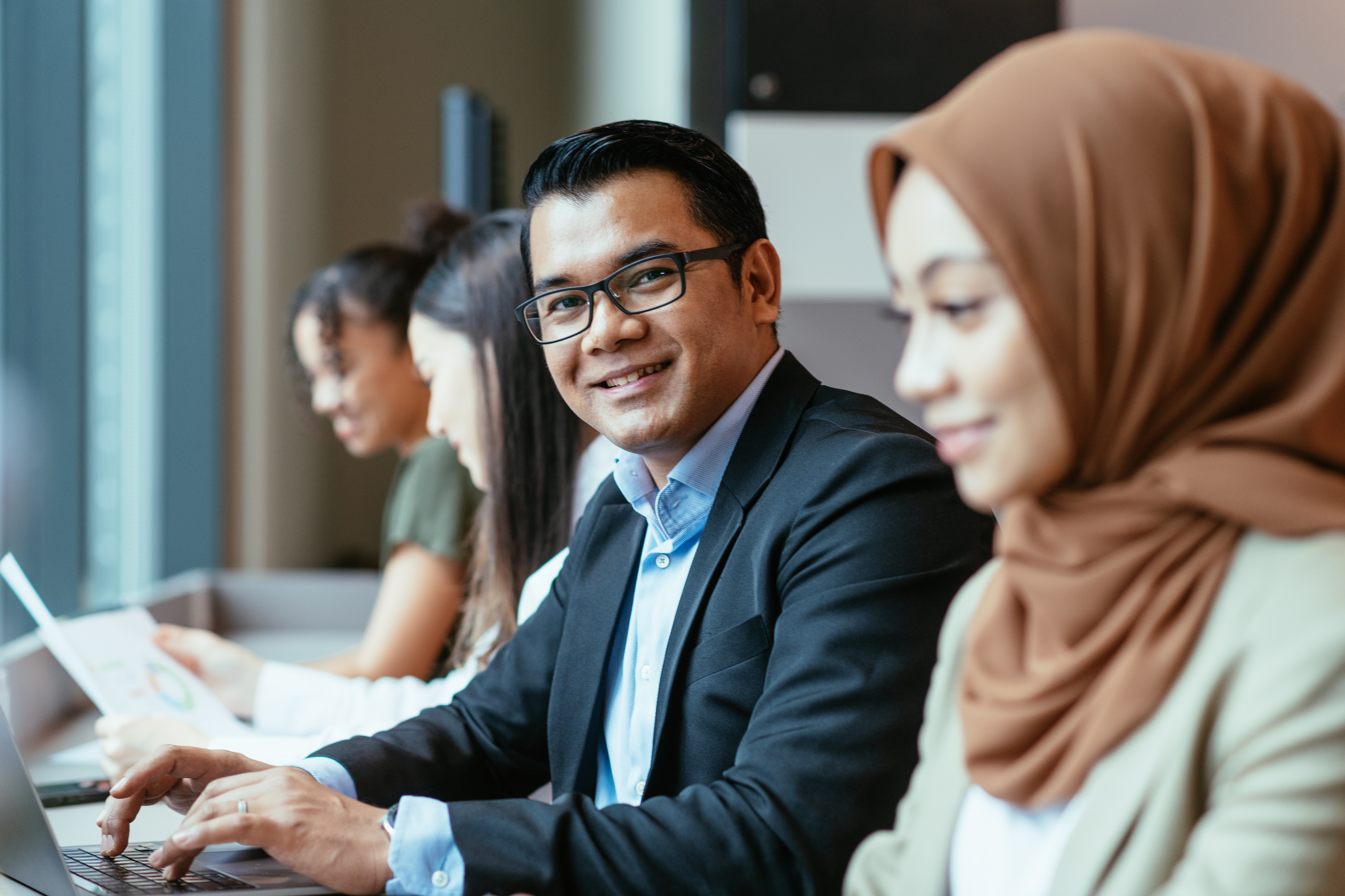 Profesional muda bekerjasama di pejabat dengan manfaat pekerja moden