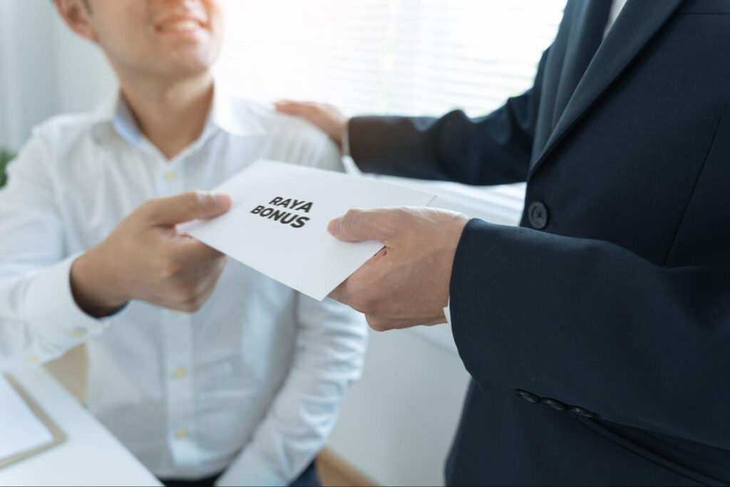 SME employee receiving a Raya bonus from a manager