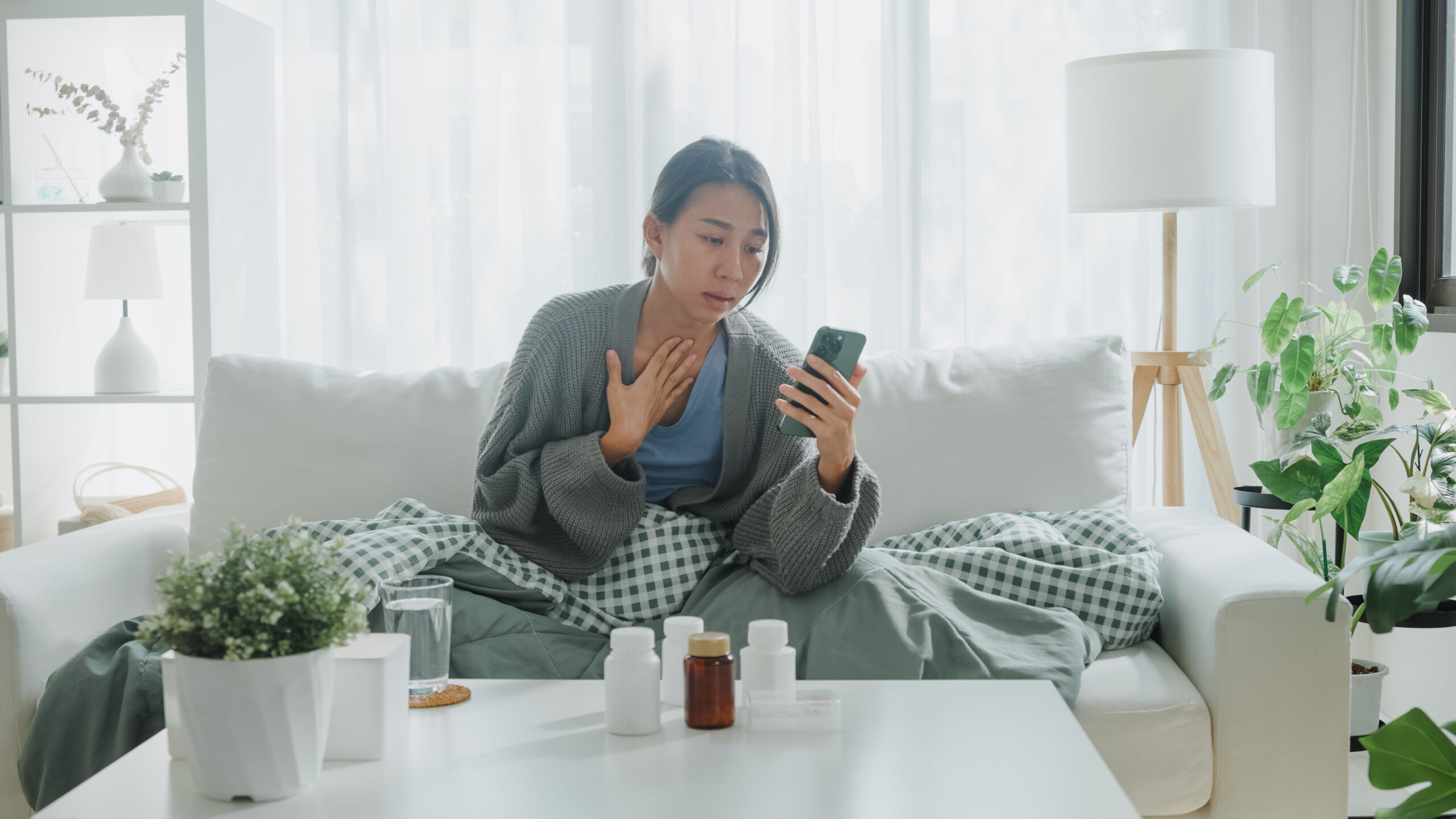 Unwell woman monitoring her fever symptoms