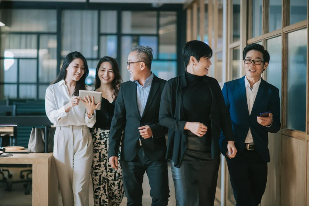 A team walking and talking together in an office corridor