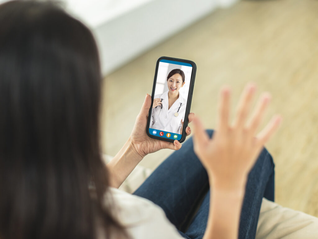 A person having a telehealth video consultation with a doctor