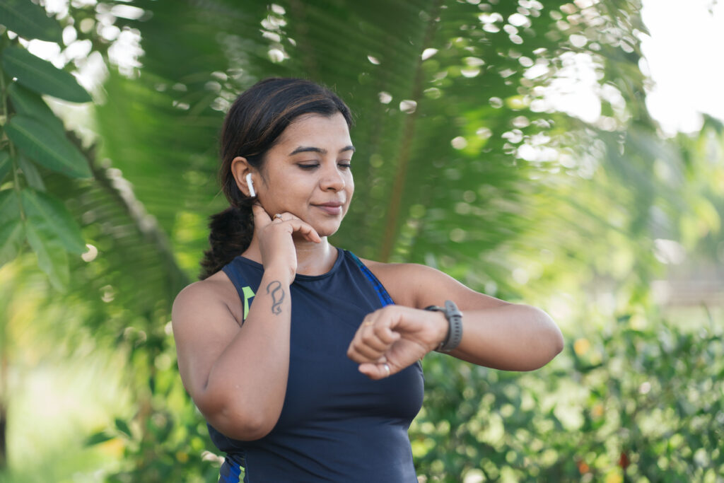 Woman monitoring her fitness data using health apps tracking