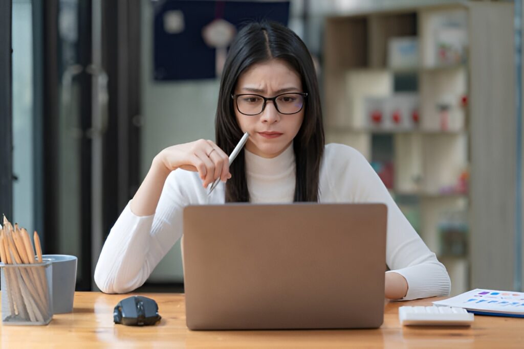 Woman reviewing employee healthcare benefits on laptop at desk