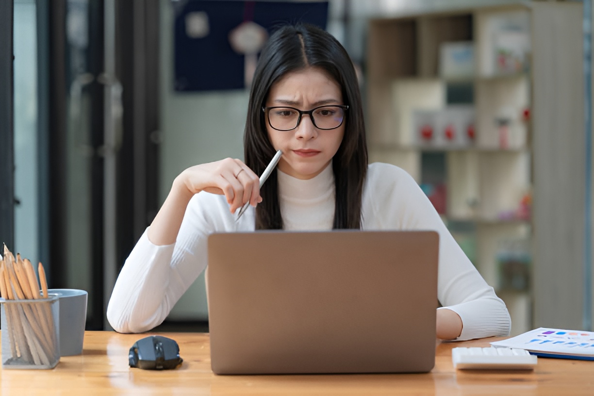 Woman reviewing employee healthcare benefits on laptop at desk